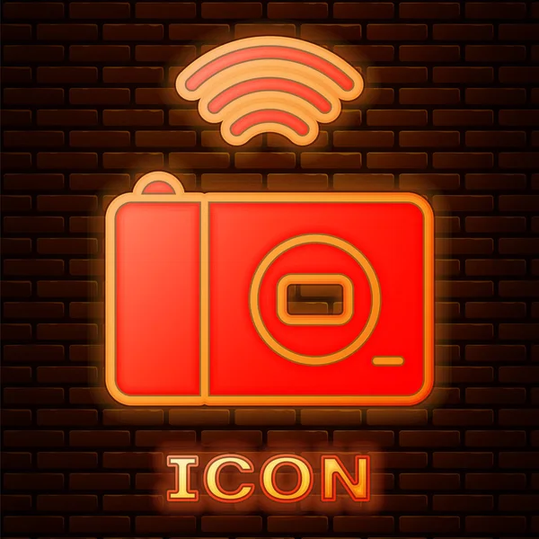 Glowing neon Smart photo camera system icon isolated on brick wall background. Internet of things concept with wireless connection. Vector — Stock Vector