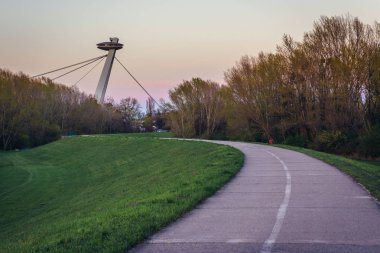 So called UFO Bridge seen from cycle path on a embankment of Danube River in Bratislava, Slovakia clipart