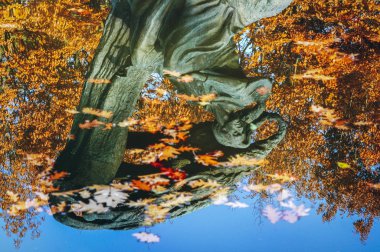 Reflection of Polish composer and virtuoso pianist Frederic Chopin monument in Royal Baths Park in Warsaw, capital of Poland
