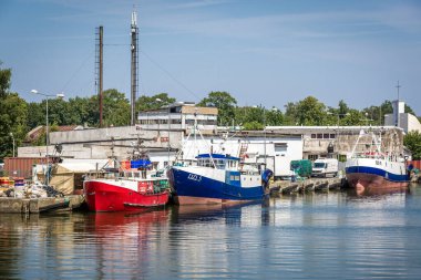 Dziwnow, Poland - June 26, 2019: Fishboats in port of Dziwnow town in north western Poland situated on the Baltic Sea coast clipart