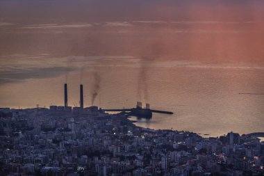 Sunset over Mediterranean Sea coast in Lebanon, view with Zouk Power Plant in Zouk Mikael city
