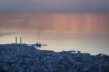 Sunset over Mediterranean Sea coast in Lebanon, view with Zouk Power Plant in Zouk Mikael city