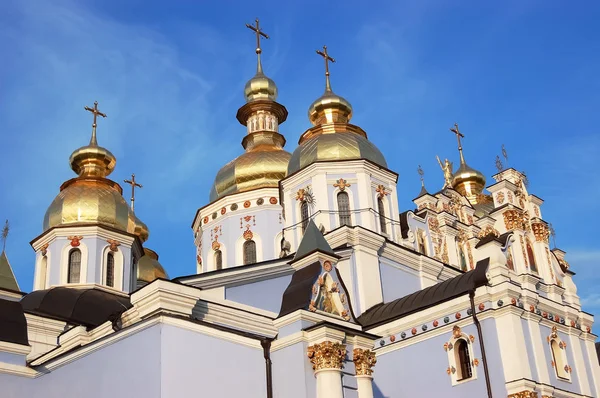 View of the shining domes of the St. Michael the Golden-Domed Cathedral in Kiev in the rays of the setting sun, the Cathedral of the Orthodox Church of Ukraine.