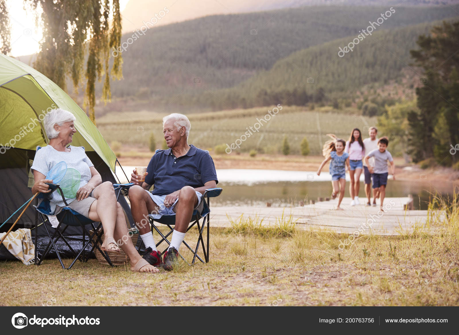 multi generation family camping trip lake together stock photo