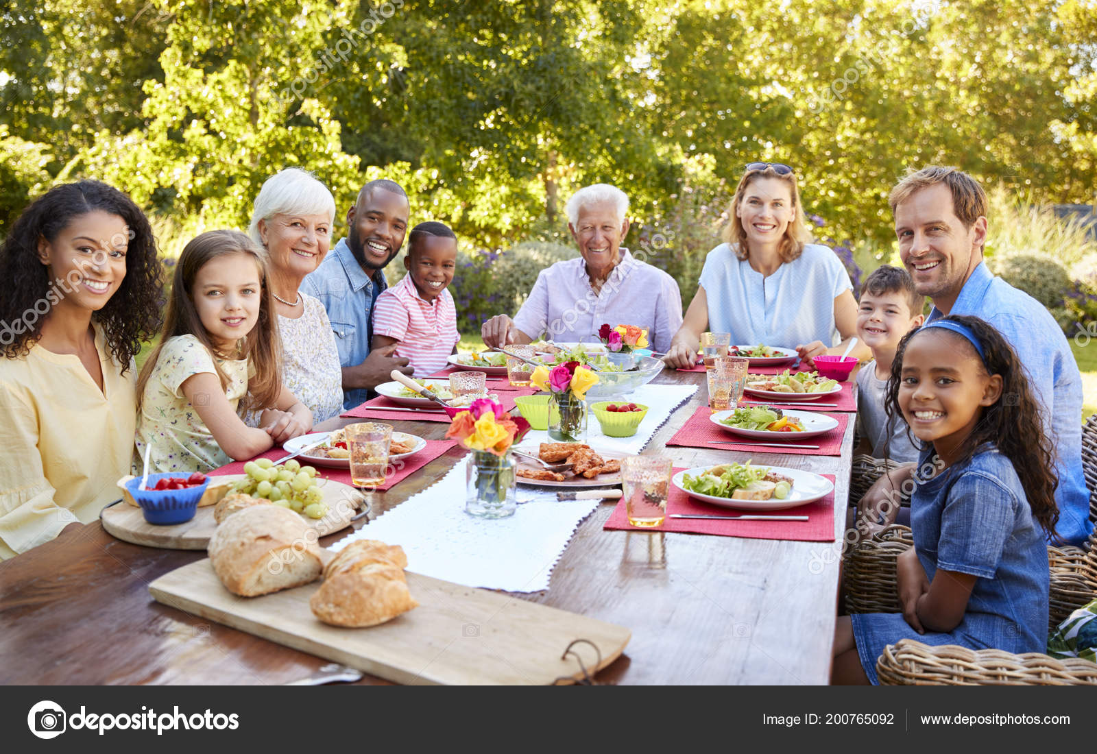 Friends Family Having Lunch Garden Looking Camera Stock Photo Image By C Monkeybusiness 200765092