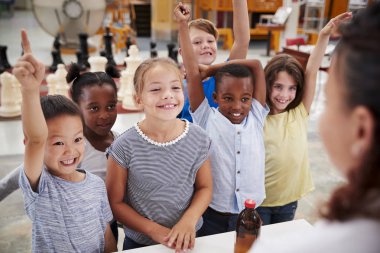 Group of kids volunteering to answer teachers question clipart