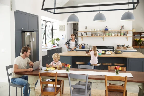 Young white family busy in their kitchen, elevated view