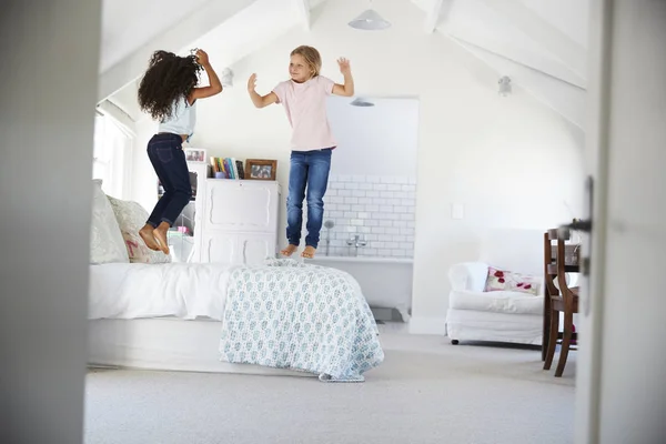 Счастливые Юные Подруги Прыгают Кровати Спальне — стоковое фото