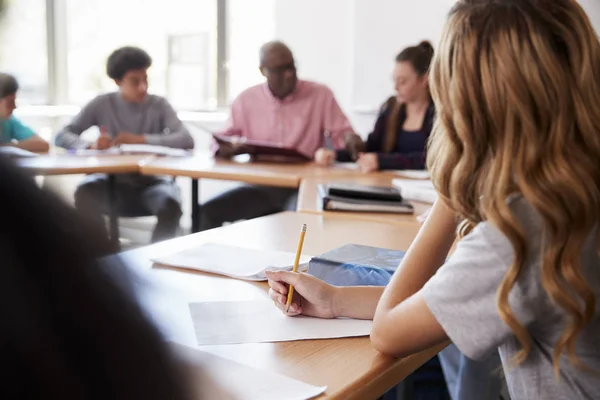 Female High School Student Writing Notes Whilst Sitting Desk Class — Stock Photo, Image