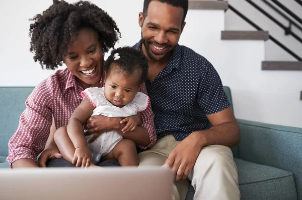 Gezin Met Baby Dochter Thuis Zitten Bank Kijken Naar Laptopcomputer — Stockfoto