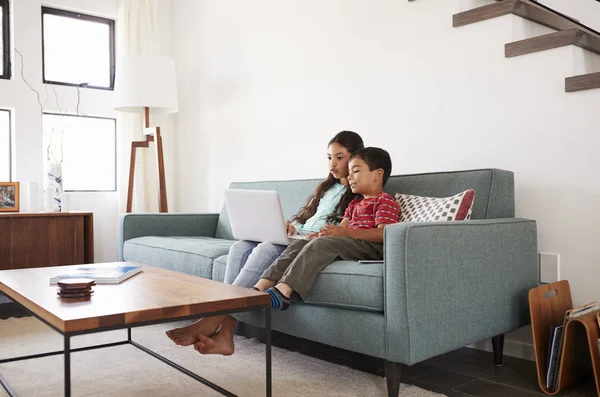 Bruder Und Schwester Sitzen Auf Sofa Und Spielen Zusammen Laptop — Stockfoto