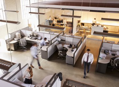 Elevated view of staff working in busy open plan office clipart