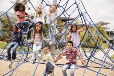 Elementary school kids climbing in school playground clipart