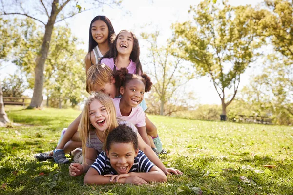 Multi Ethnic Group Children Lying Pile Park — Stock Photo, Image