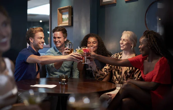 Grupo Jovens Amigos Sentados Torno Mesa Fazendo Brinde Bar Noite — Fotografia de Stock