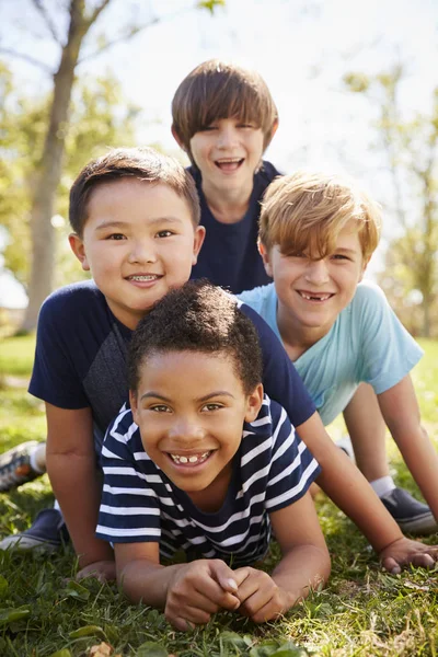 Four Schoolboys Lying Each Other Park — Stock Photo, Image