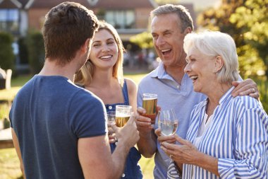 Parents With Adult Offsprings Enjoying Outdoor Summer Drink At Pub clipart