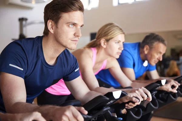 Close Up Of Group Taking Spin Class In Gym