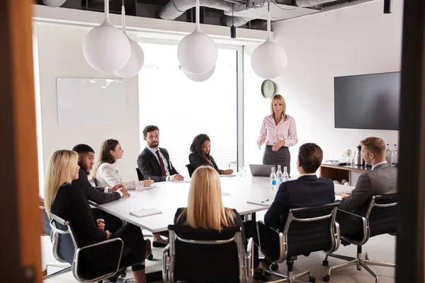 Mature Businesswoman Addressing Group Meeting Table Graduate Recruitment Assessment Day — Stock Photo, Image