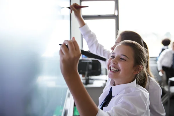 Female High School Students Wearing Uniform Using Interactive Whiteboard Lesson — Stock Photo, Image