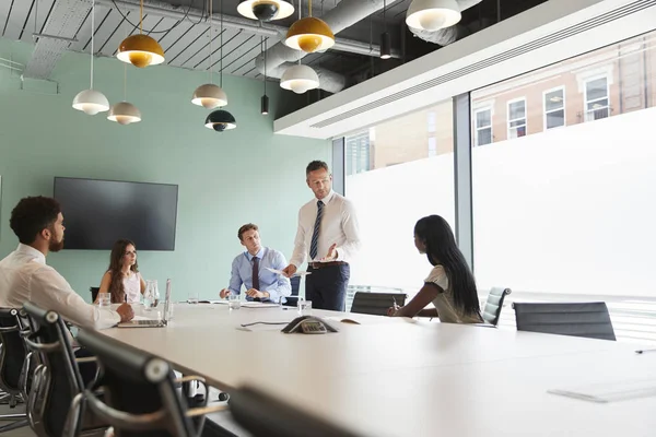 Mature Businessman Giving Boardroom Presentation Colleagues Meeting Room — Stock Photo, Image