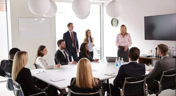 Mujer Negocios Madura Dirigiéndose Reunión Grupo Alrededor Mesa Día Evaluación —  Fotos de Stock