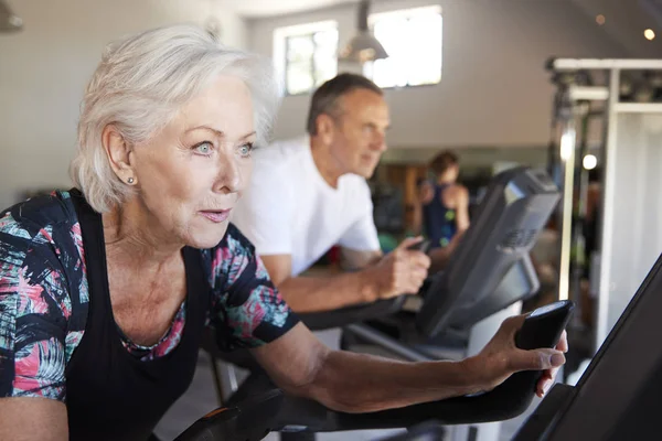 Active Senior Couple Exercising Cycling Machines Gym — Stock Photo, Image