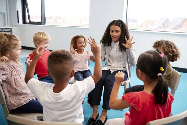 Class Infant School Children Sitting Chairs Circle Classroom Raising Hands — Stock Photo, Image