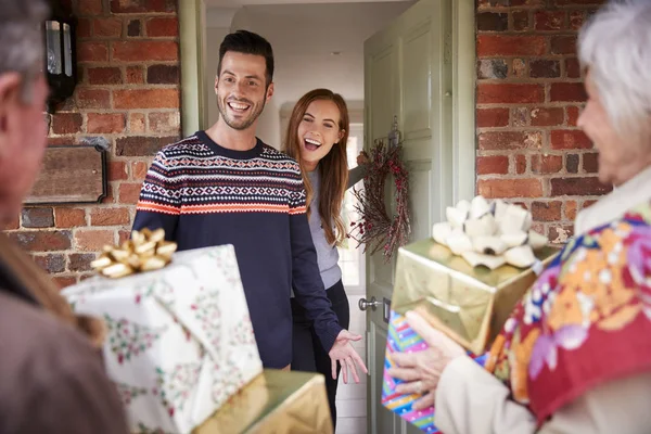 Senior Parents Being Greeted Adult Offspring Arriving Visit Christmas Day — Stock Photo, Image