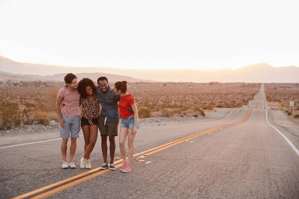 Four Young Adult Friends Standing Desert Highway Talking — Stock Photo, Image