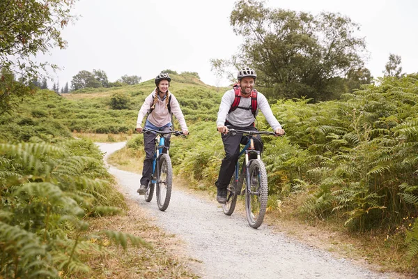 Young Adult Couple Riding Mountain Bikes Countryside Full Length — Stock Photo, Image