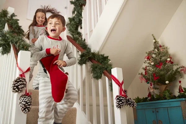 Dos Niños Emocionados Usando Pijamas Corriendo Por Las Escaleras Sosteniendo — Foto de Stock