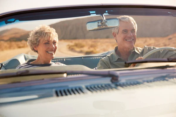 在公路旅行中的老年夫妇 透过汽车挡风玻璃看到 — 图库照片