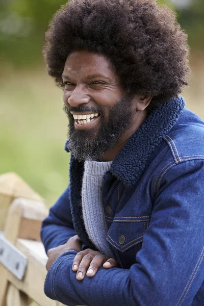 Black Man Leaning Wooden Fence Countryside Laughing Close — Stok fotoğraf