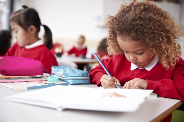 Mixed Race Schoolgirl Wearing School Uniform Sitting Desk Infant School — Stock Photo, Image