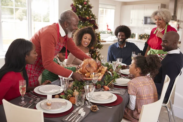 Grandfather Bringing Roast Turkey Dinner Table Multi Generation Mixed Race Stock Photo