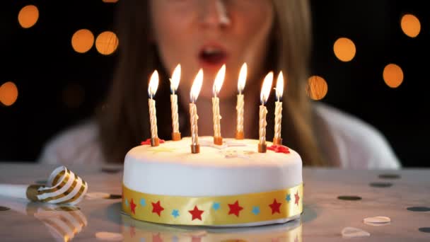 Close Woman Blowing Out Seven Lit Candles White Decorated Birthday — Stock Video