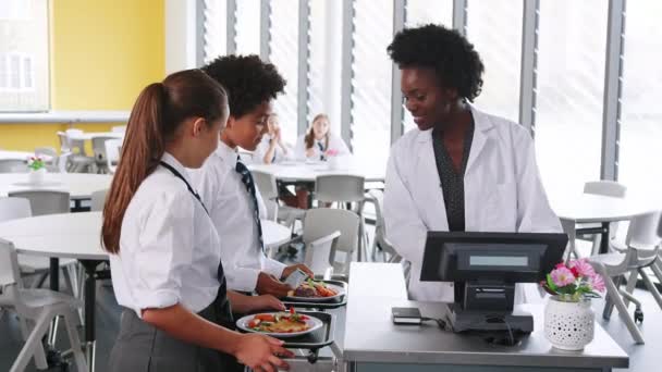 High School Students Wearing Uniform Paying School Meal Cafeteria Using — Stock Video