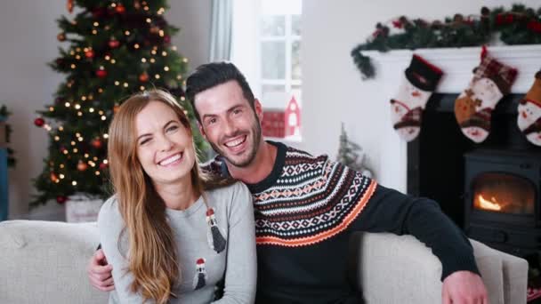 Portrait Couple Wearing Christmas Jumpers Sitting Sofa Home Together Shot — Stock Video