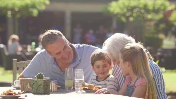 Grootouders Met Kleinkinderen Genieten Van Summer Outdoor Pub Lunch Shot — Stockvideo