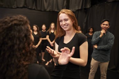 Teacher With Male And Female Drama Students At Performing Arts School In Studio Improvisation Class clipart