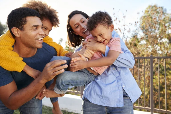 Young Mixed Race Parents Playing Outdoors Carrying Children Garden — Stock Photo, Image