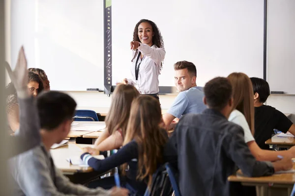 Female High School Teacher Asking Question Standing Interactive Whiteboard Teaching — Stock Photo, Image