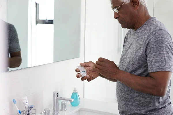 Senior Man Flossing Teeth Standing Next Bathroom Mirror Wearing Pajamas — Stock Photo, Image