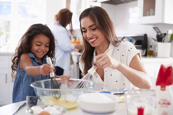 Young Girl Making Cake Kitchen Her Mum Grandmother Busy Background — Stock Photo, Image