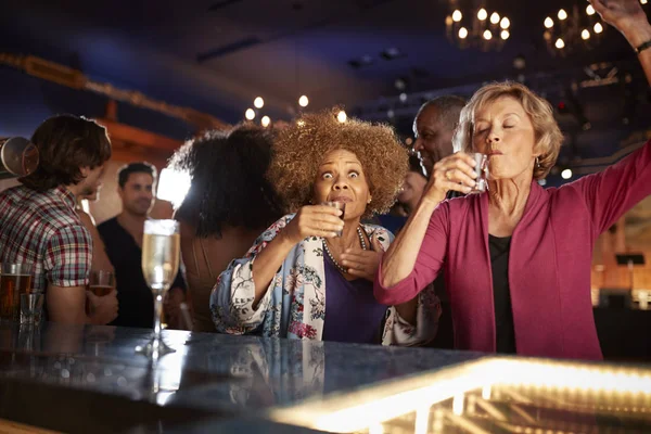 Female Senior Friends Drinking Shots Bar Together — Stock Photo, Image