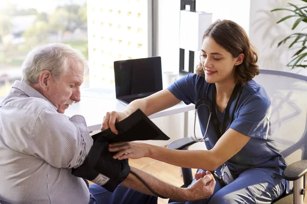 Nurse Wearing Scrubs Office Checking Senior Male Patient Blood Pressure — Stock Photo, Image
