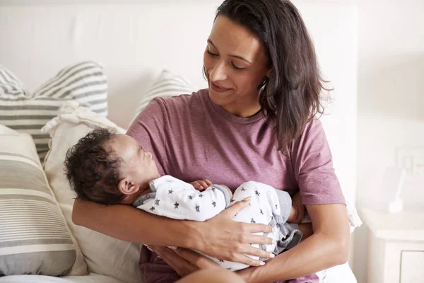 Young Mixed Race Adult Mother Sitting Her Bed Holding Her — 스톡 사진