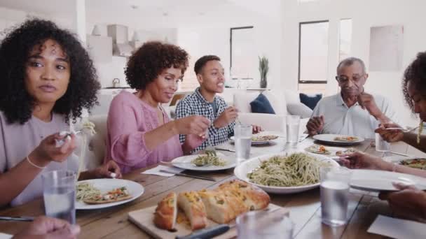 Three Generation Black Family Sitting Dinner Table Serving Spaghetti Panning Stock Video