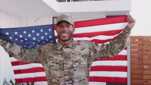 Millennial Black Male Soldier Steps Camera Holding Flag Smiling Camera — Stock Video